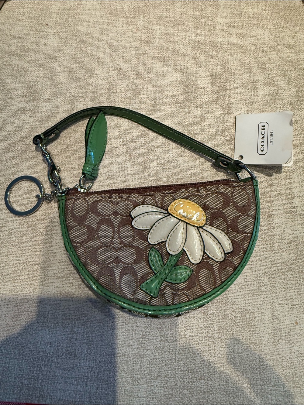 Coach Brown Signature Wristlet with Green Trim and Daisy Motif